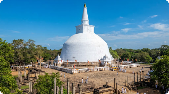 Travelers at a white stupa